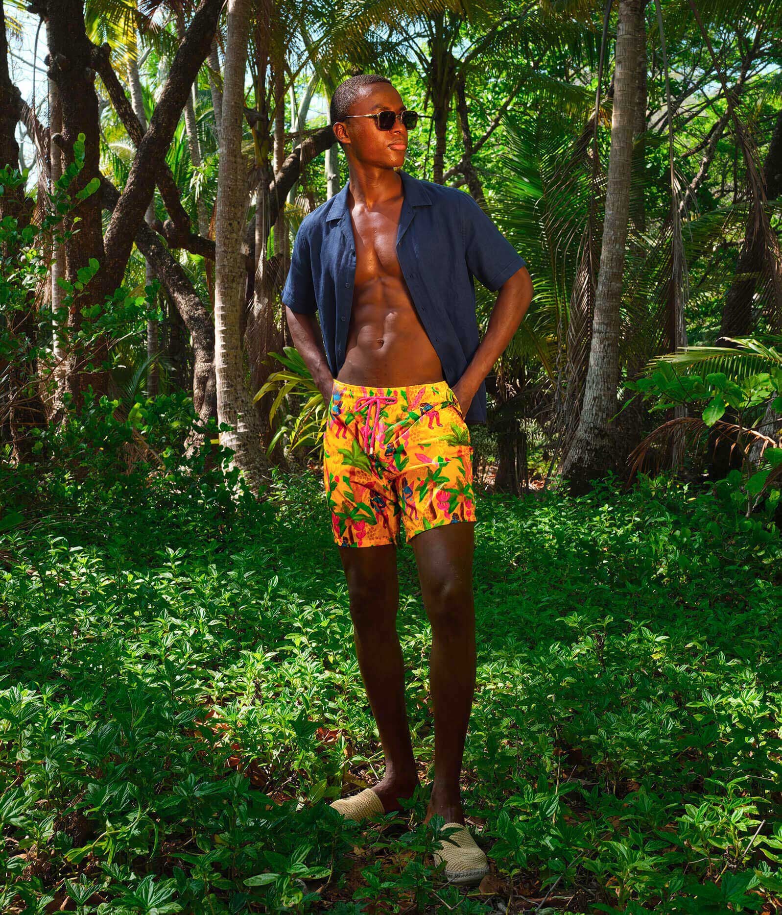 Tropicalia print from the new collection Cruise 2027 A man in the jungle wearing matching shirt and swim shorts.